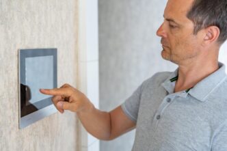 Friends installing a budget-friendly home security camera in a warm, inviting living room.