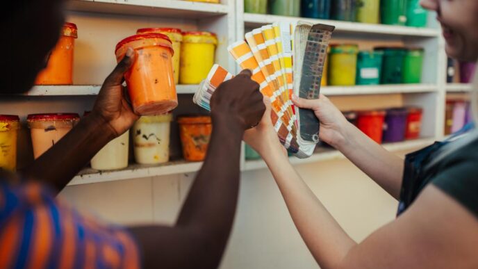 A vibrant DIY workspace with paint cans, tools, and a partially finished chair.